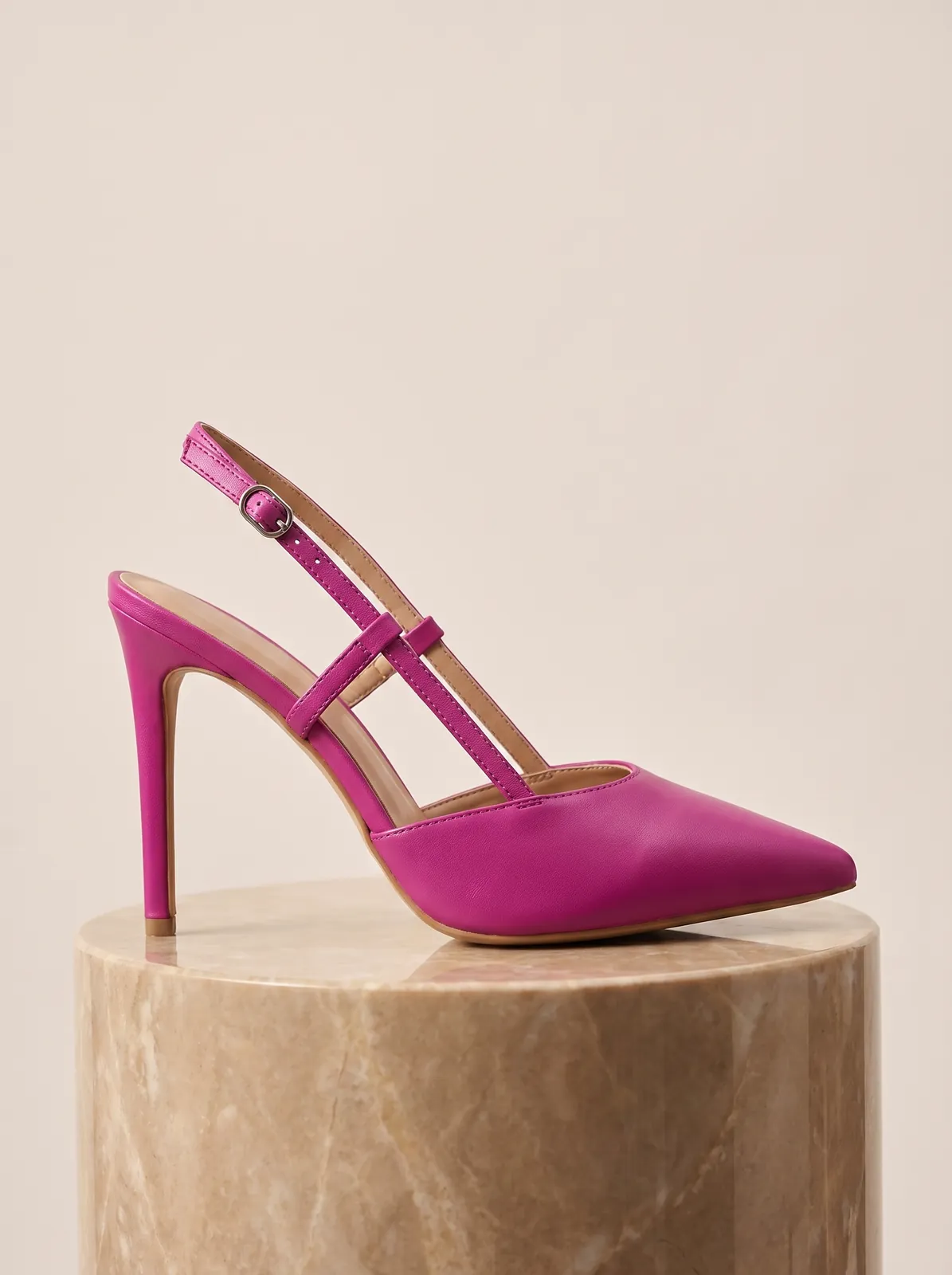 Pink slingback heel on a marble pedestal, clean e-commerce footwear product photo